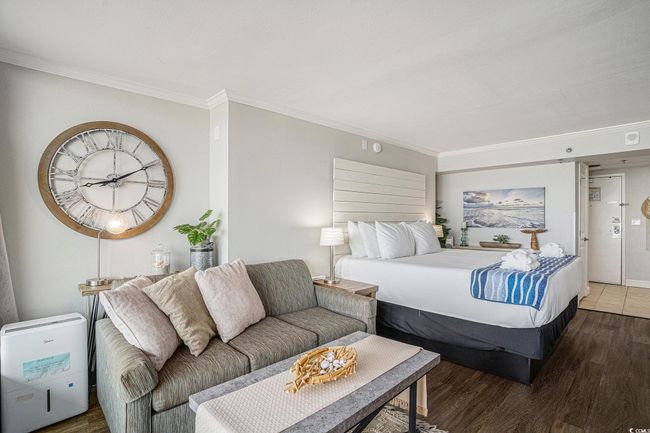 Bedroom featuring ornamental molding and wood finished floors | Image 8