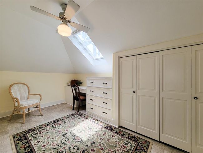Bright upstairs hobby room with a skylight, ample closet space, and potential to serve as a fourth bedroom. | Image 29