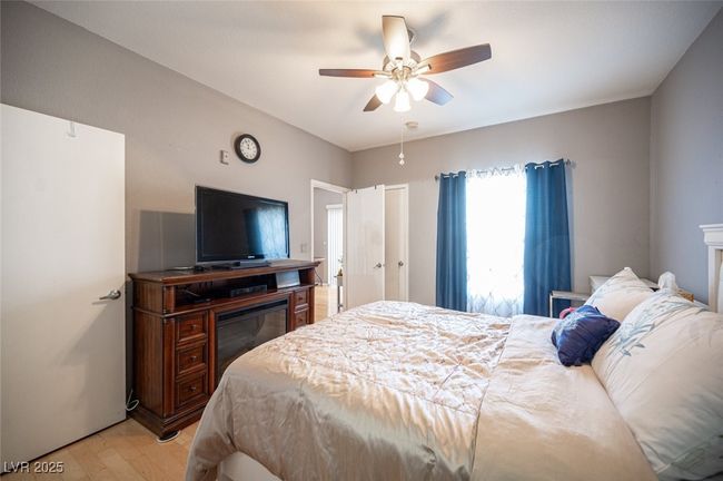 Bedroom featuring light wood-style flooring and ceiling fan | Image 21