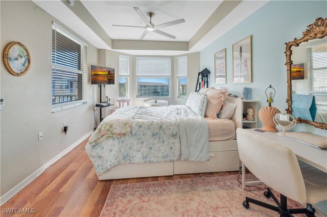 Bedroom with light hardwood / wood-style floors and ceiling fan | Image 15