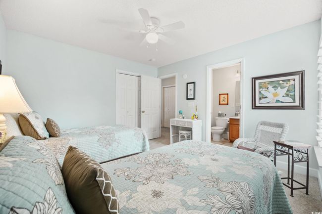 Bedroom with light carpet, a closet, ensuite bath, and a ceiling fan | Image 35