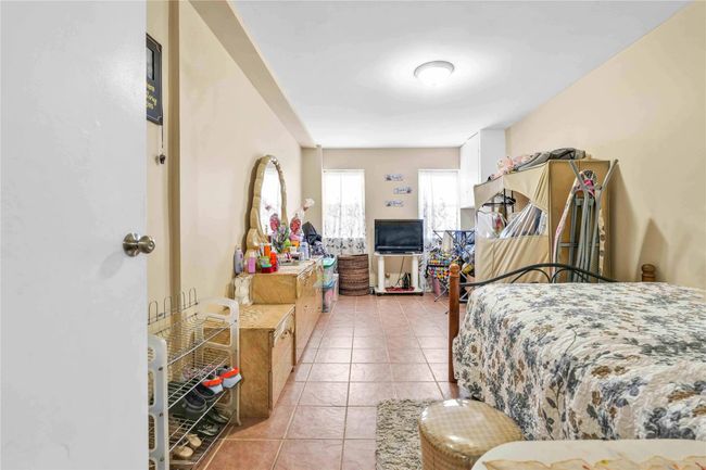 Bedroom with light tile patterned floors | Image 18