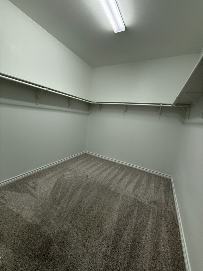 Walk in closet featuring carpet floors | Image 13