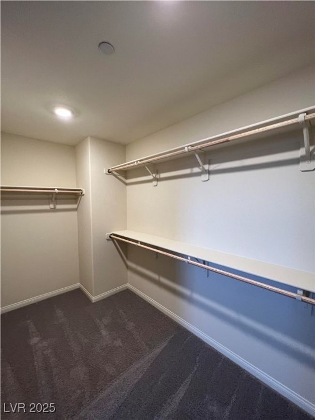 Walk in closet with dark carpet | Image 12