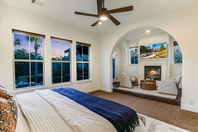 Cozy sitting area in primary bedroom with gas fireplace | Image 21
