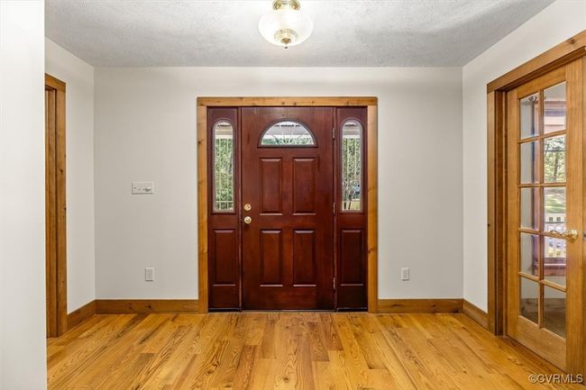 Entryway with light wood-type flooring and a textured ceiling | Image 27
