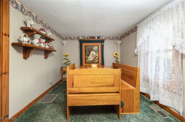 Sitting room with baseboards, visible vents, and wallpapered walls | Image 15