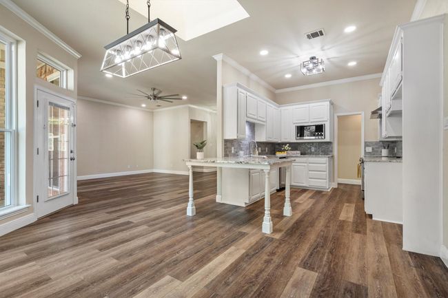 A view of the kitchen and living room from the breakfast area. | Image 13