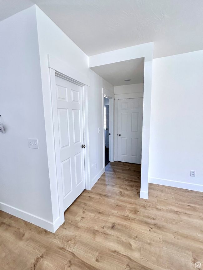 Corridor with light wood finished floors and baseboards | Image 11