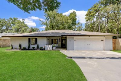 Double driveway leads to 2 car garage. Welcoming front door! | Image 1