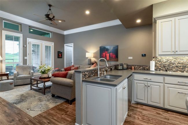 Kitchen with wood-like tile flooring running throughout lower level. | Image 10