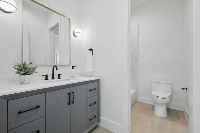 Bathroom with baseboards, toilet, tile patterned floors, and vanity | Image 28