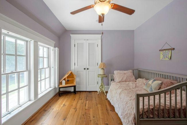 Bedroom featuring light wood-type flooring, a closet, a ceiling fan, and baseboards | Image 30