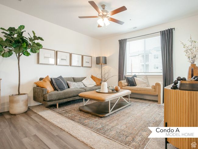Living room with wood finished floors, a ceiling fan, and visible vents | Image 7