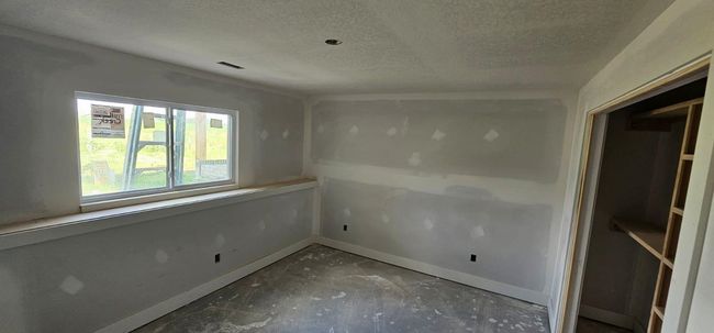 Empty room with a textured ceiling | Image 16