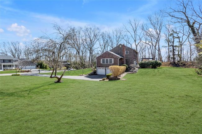 View of yard featuring driveway and an attached garage | Image 23