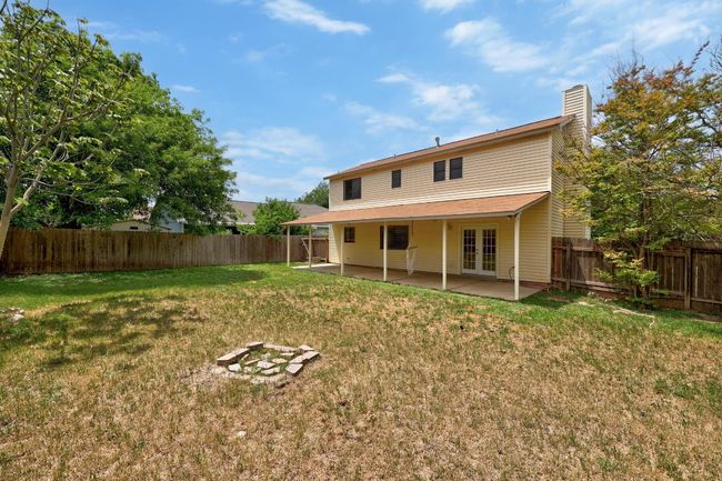 Rear view of property with french doors, a patio area, a fenced backyard, and a lawn | Image 27