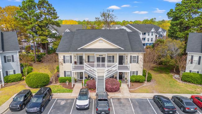 View of front of home with stairs, uncovered parking, a front lawn, a porch, and a shingled roof | Image 30