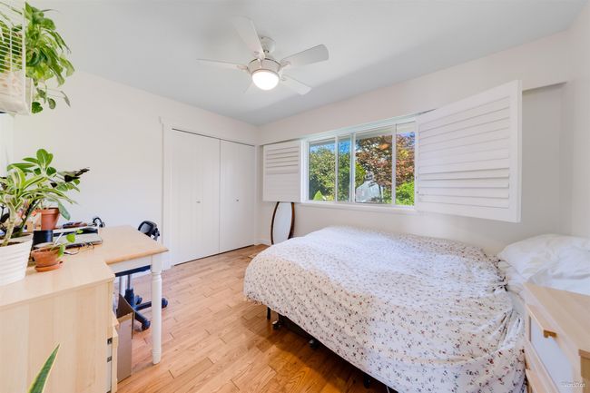 Bedroom with light wood-style floors, a ceiling fan, and a closet | Image 24