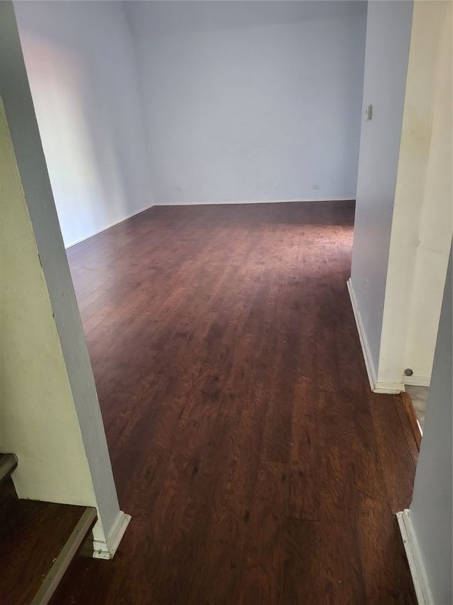 Empty room with baseboards and dark wood-style floors | Image 13