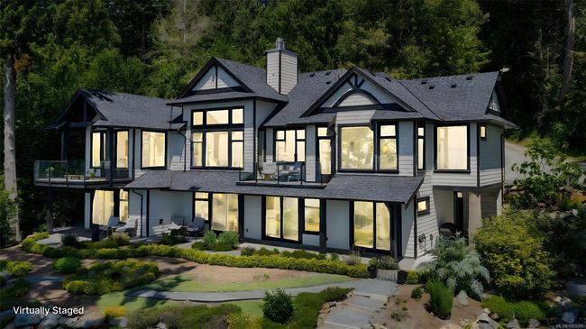 Back of house featuring a shingled roof, a chimney, a patio area, a balcony, and a view of trees | Image 95