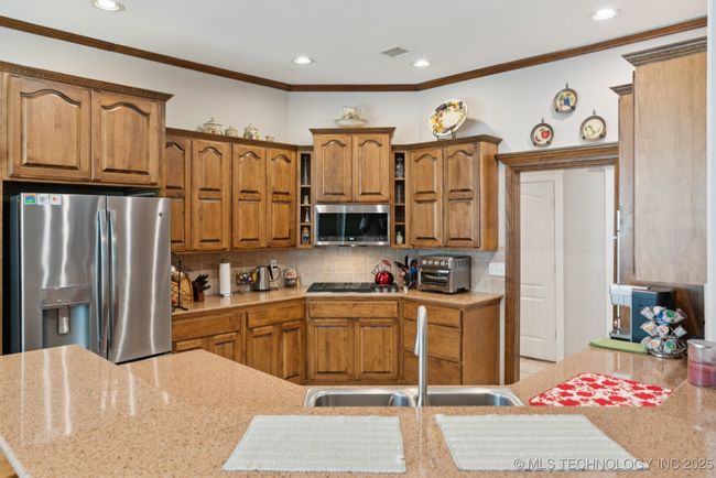 Lots of cabinet space, Corian countertops, 5 burner cooktop, microwave and double convection oven! | Image 16