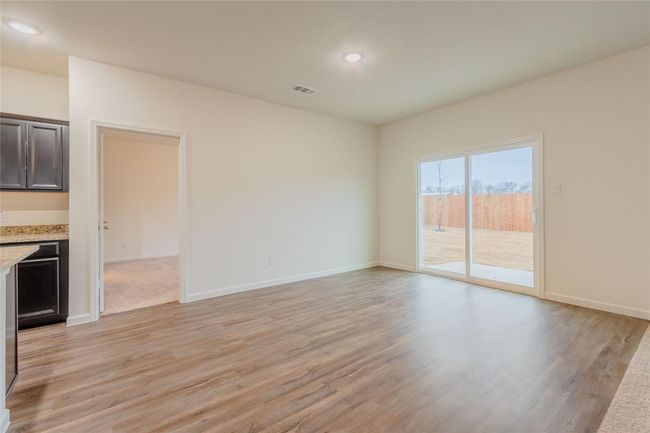 Unfurnished living room with light wood-type flooring, baseboards, and recessed lighting | Image 11