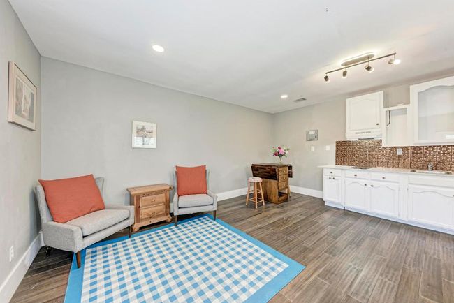Living area featuring recessed lighting, baseboards, and dark wood-type flooring | Image 31