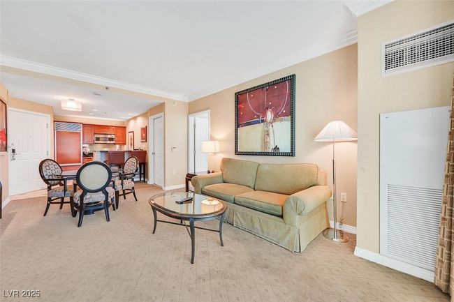 Living area featuring baseboards, crown molding, and light colored carpet | Image 14