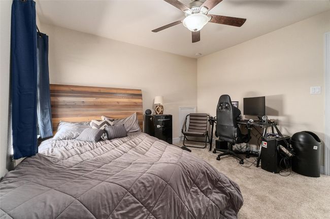 Carpeted bedroom with ceiling fan | Image 23
