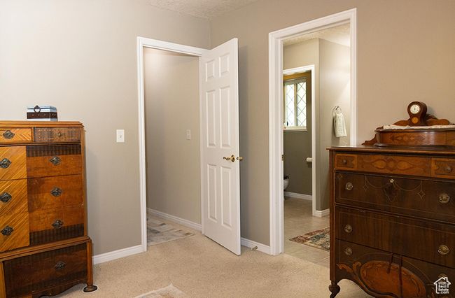Bedroom with light colored carpet and baseboards | Image 13