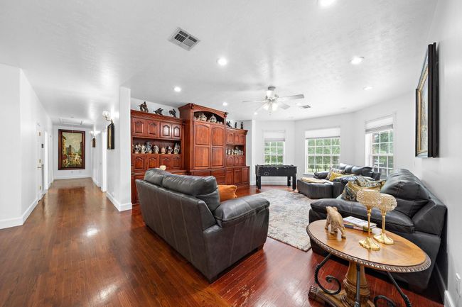 Spacious family room with large windows and a cozy atmosphere | Image 27