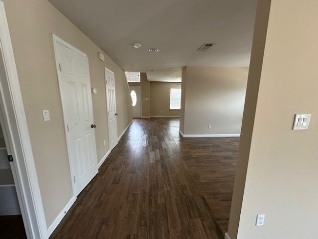 Hall featuring dark wood finished floors and baseboards | Image 10