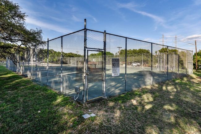 View of tennis court with a gate and fence | Image 30
