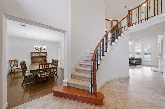 a grand staircase sets the tone at the entry, leading to the formal dining room, private study and opens up to the living room. | Image 7