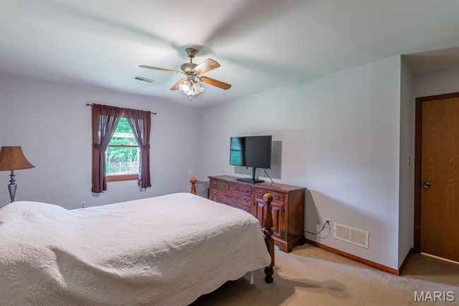 Bedroom with light carpet and ceiling fan | Image 13
