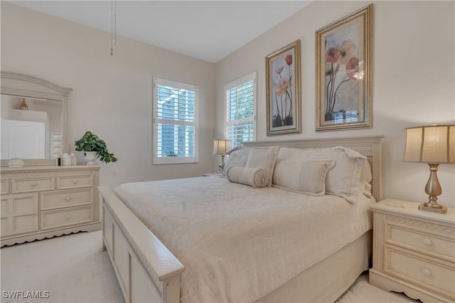 Bedroom featuring light carpet | Image 15