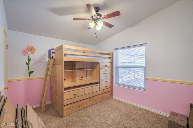 Bedroom featuring vaulted ceiling, carpet flooring, baseboards, and ceiling fan | Image 24