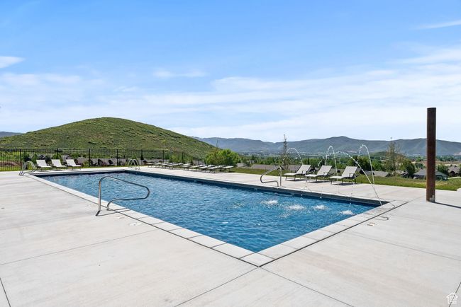 Pool featuring fence, a patio area, and a mountain view | Image 9
