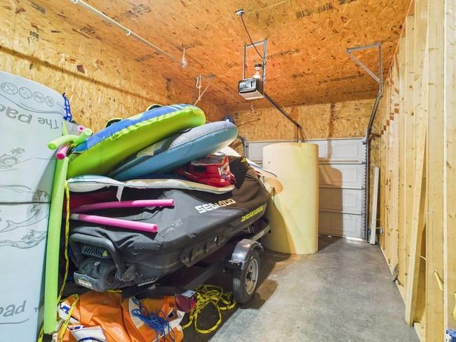 Garage featuring a garage door opener | Image 72
