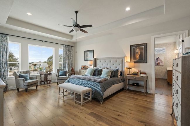 Bedroom with a raised ceiling, baseboards, and hardwood / wood-style flooring | Image 28