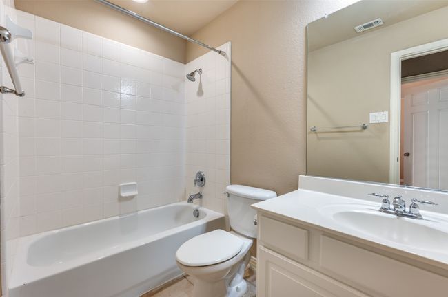 Full upstairs Bathroom featuring tub / shower combination, vanity, and a textured wall | Image 19