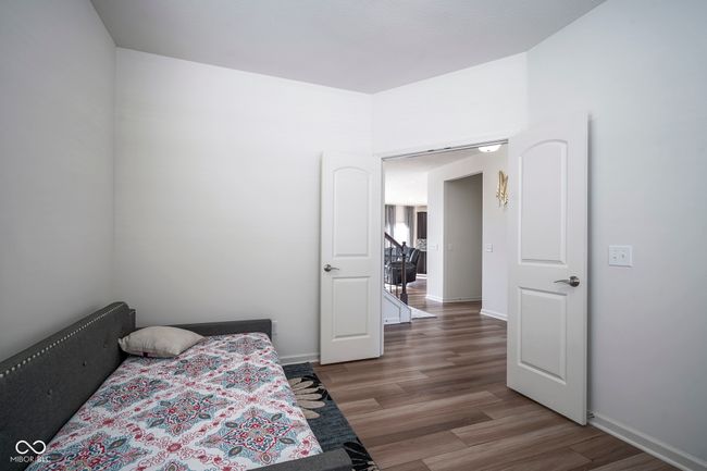 bedroom featuring baseboards and wood finished floors | Image 9