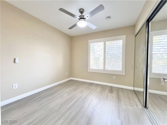2nd Bedroom with contemporary ceiling fan w/ LED light and mirror closet door | Image 8
