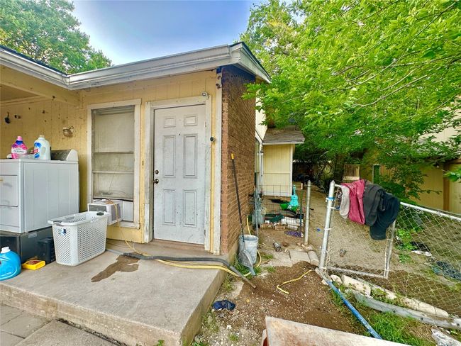 Doorway to property with washer / clothes dryer, cooling unit, and brick siding | Image 4