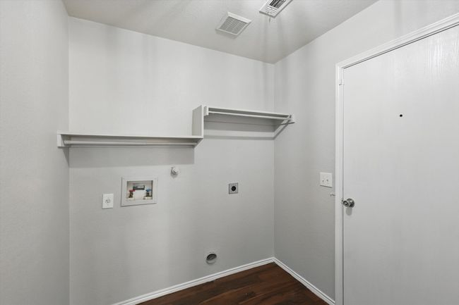 Laundry room with hookup for an electric dryer, dark wood-type flooring, gas dryer hookup, and washer hookup | Image 24