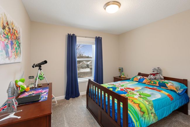 One of three additional secondary bedrooms on the upper level. | Image 17