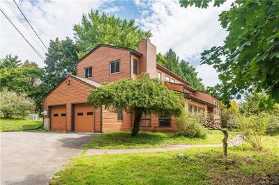 View of front facade with a front yard and a garage | Image 2