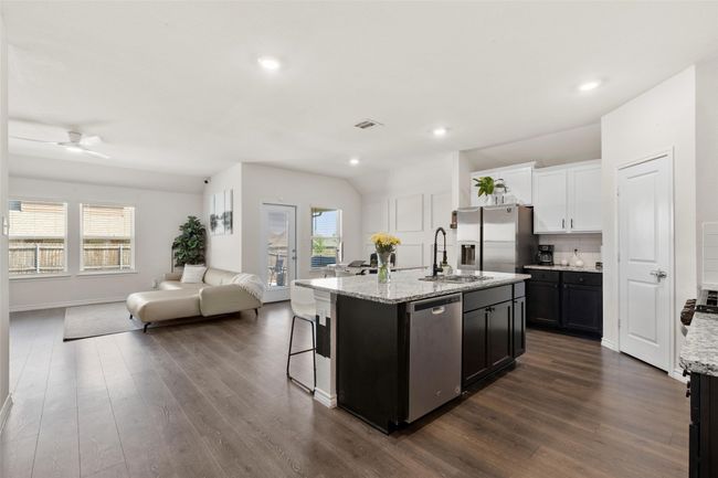 Kitchen with open floor plan, a ceiling fan, dark wood-style flooring, and appliances with stainless steel finishes | Image 13