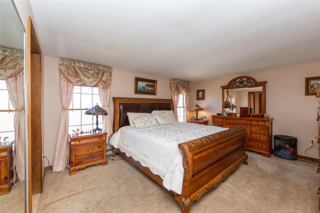 Primary Bedroom with light colored carpet | Image 37